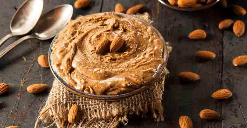 513070847 Raw Organic Almond Butter on a Background